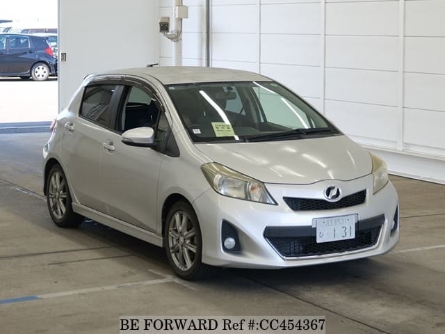 A grey JDM sports car speeding down a highway at night.