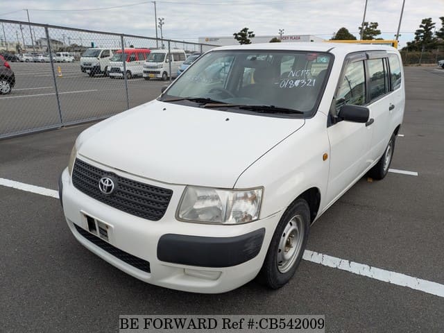 A grey JDM sports car speeding down a highway at night.