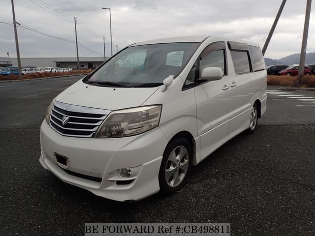 A grey JDM sports car speeding down a highway at night.