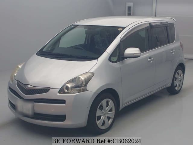 A grey JDM sports car speeding down a highway at night.