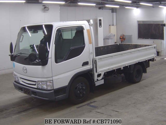 A grey JDM sports car speeding down a highway at night.