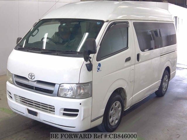 A grey JDM sports car speeding down a highway at night.