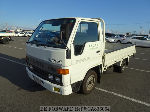 A grey JDM sports car speeding down a highway at night.