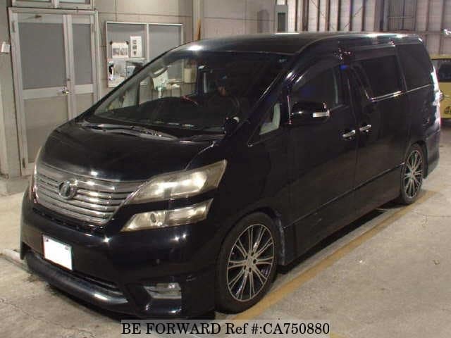 A grey JDM sports car speeding down a highway at night.