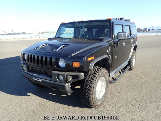 A grey JDM sports car speeding down a highway at night.