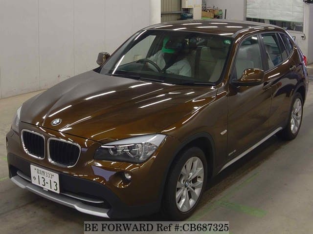 A grey JDM sports car speeding down a highway at night.