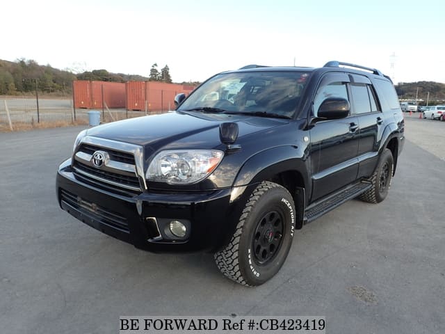 A grey JDM sports car speeding down a highway at night.