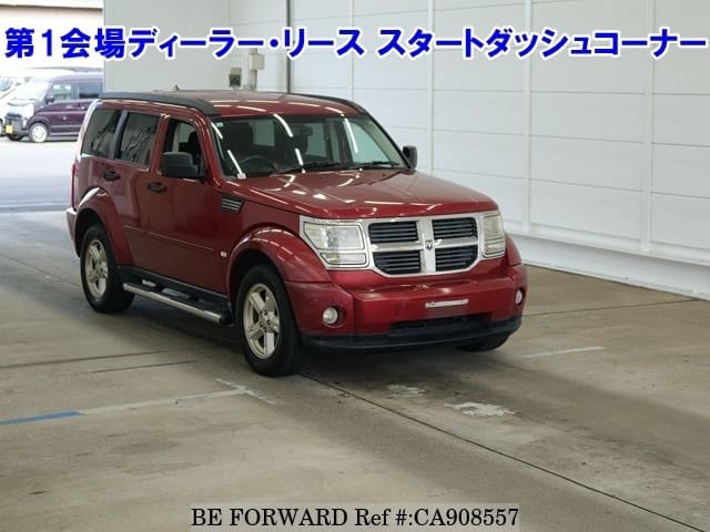 A grey JDM sports car speeding down a highway at night.