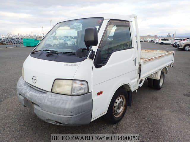 A grey JDM sports car speeding down a highway at night.