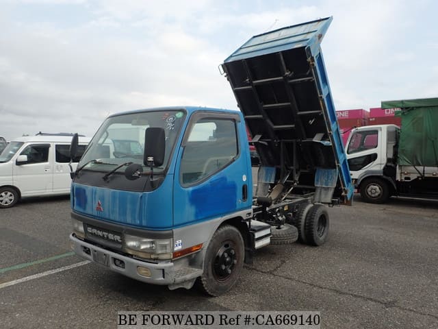 A grey JDM sports car speeding down a highway at night.