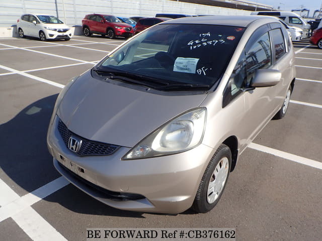 A grey JDM sports car speeding down a highway at night.