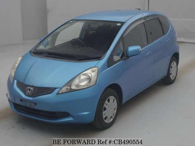 A grey JDM sports car speeding down a highway at night.