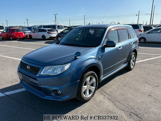 A grey JDM sports car speeding down a highway at night.