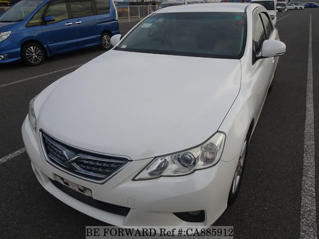 A grey JDM sports car speeding down a highway at night.