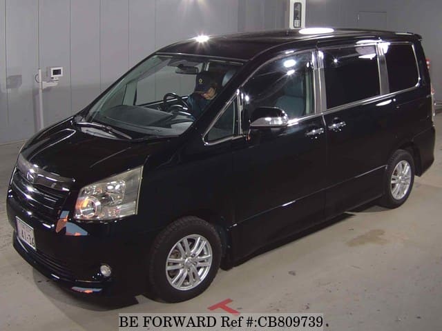 A grey JDM sports car speeding down a highway at night.