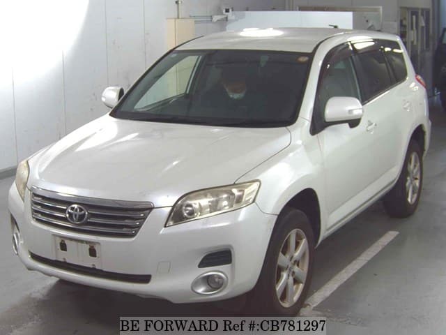 A grey JDM sports car speeding down a highway at night.