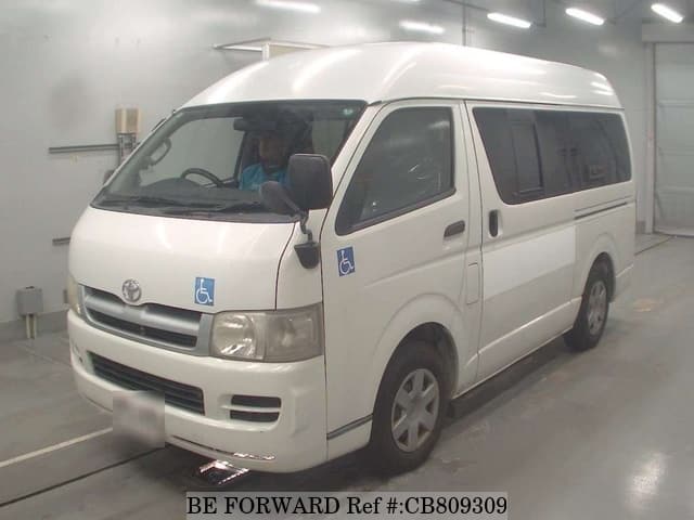 A grey JDM sports car speeding down a highway at night.