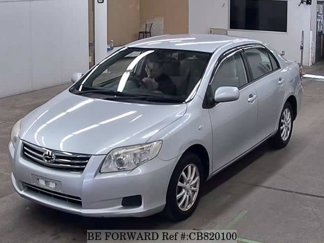A grey JDM sports car speeding down a highway at night.