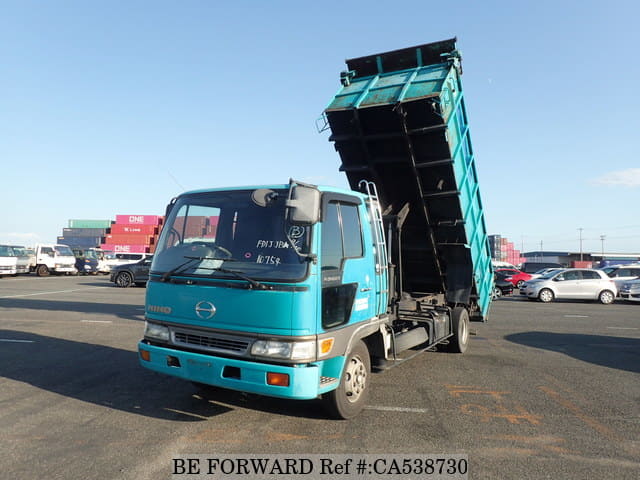 A grey JDM sports car speeding down a highway at night.