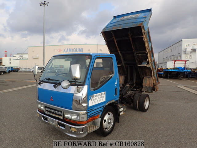 A grey JDM sports car speeding down a highway at night.