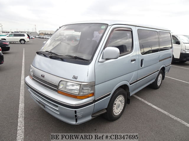 A grey JDM sports car speeding down a highway at night.