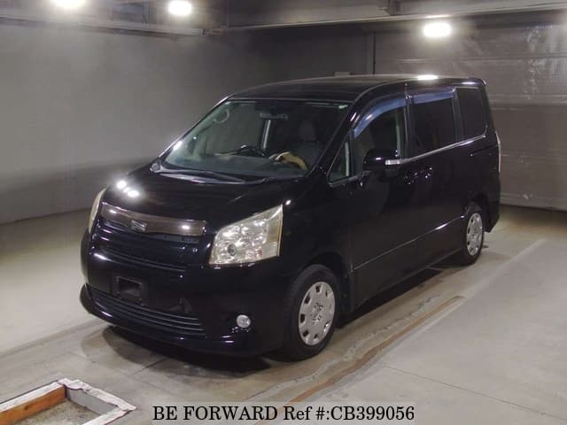 A grey JDM sports car speeding down a highway at night.