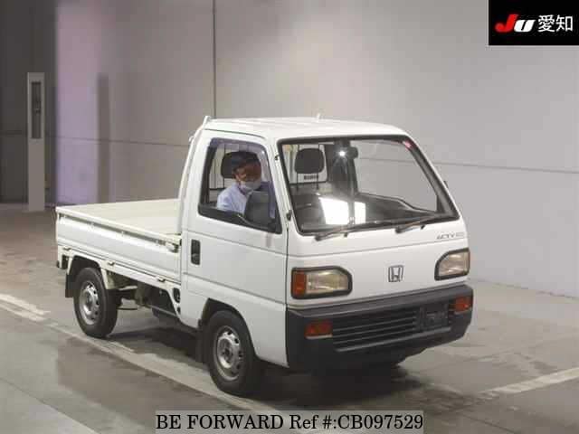 A grey JDM sports car speeding down a highway at night.