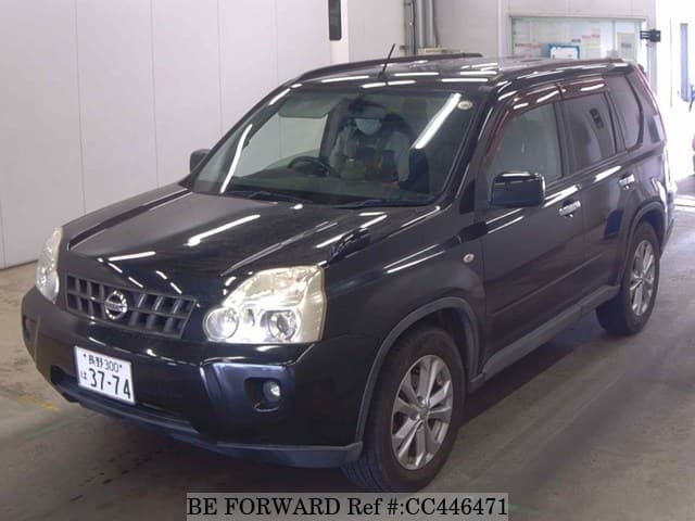A grey JDM sports car speeding down a highway at night.