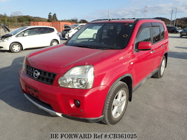 A grey JDM sports car speeding down a highway at night.
