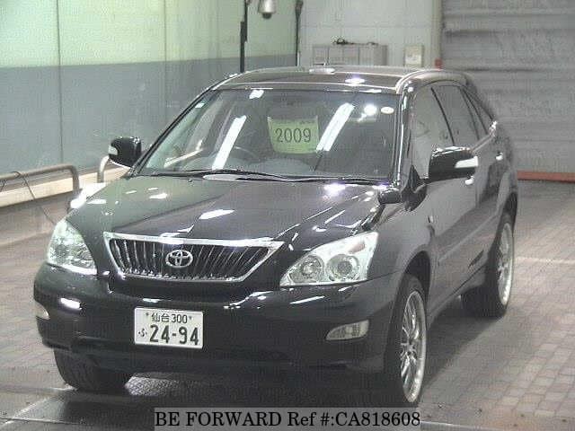 A grey JDM sports car speeding down a highway at night.