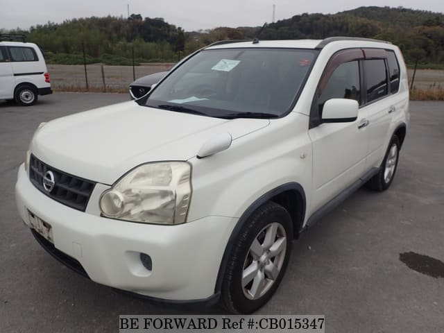 A grey JDM sports car speeding down a highway at night.