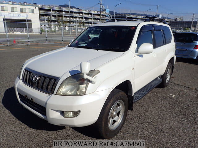 A grey JDM sports car speeding down a highway at night.