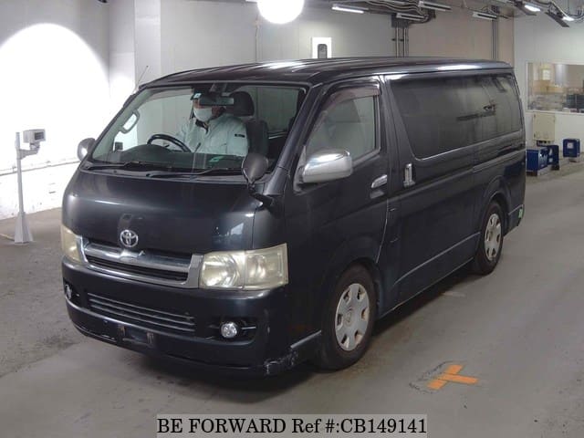 A grey JDM sports car speeding down a highway at night.