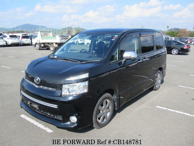 A grey JDM sports car speeding down a highway at night.