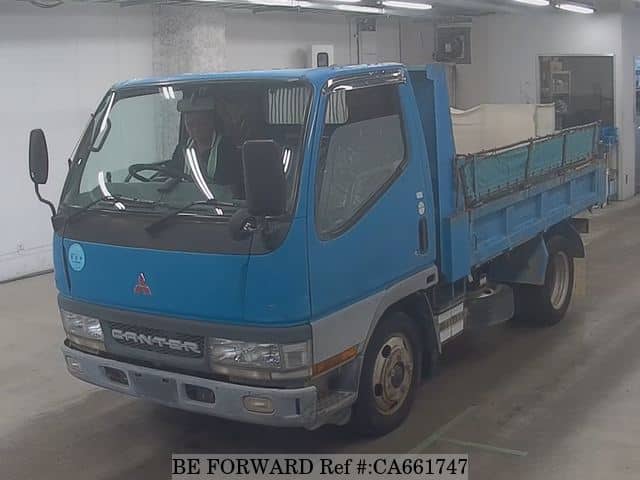 A grey JDM sports car speeding down a highway at night.