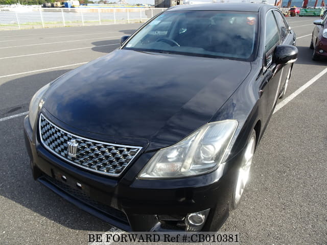 A grey JDM sports car speeding down a highway at night.