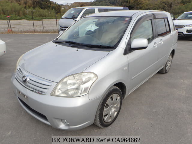 A grey JDM sports car speeding down a highway at night.