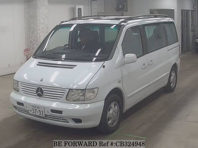 A grey JDM sports car speeding down a highway at night.