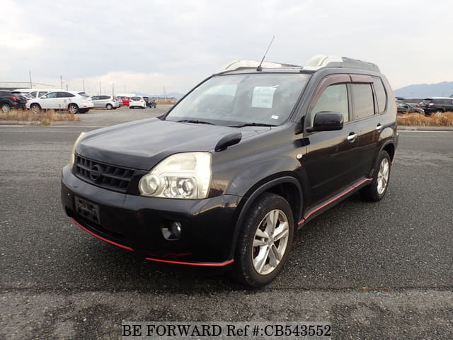 A grey JDM sports car speeding down a highway at night.