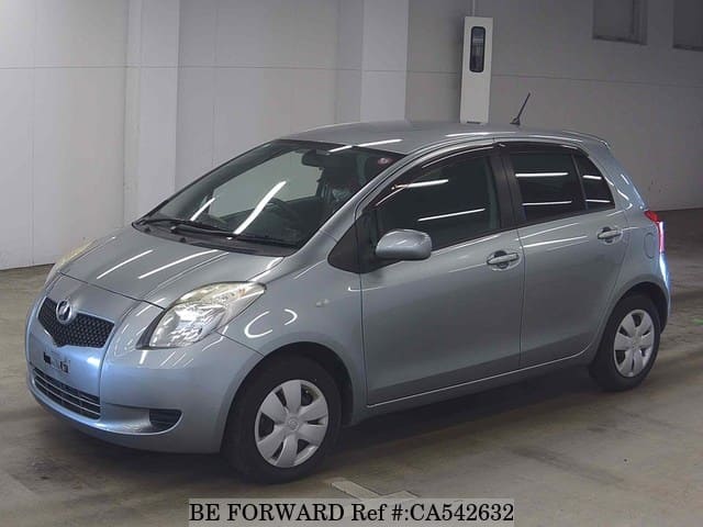 A grey JDM sports car speeding down a highway at night.