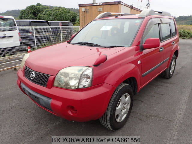 A grey JDM sports car speeding down a highway at night.