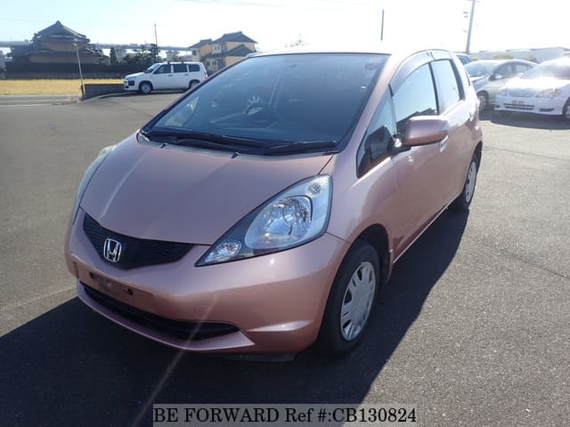 A grey JDM sports car speeding down a highway at night.