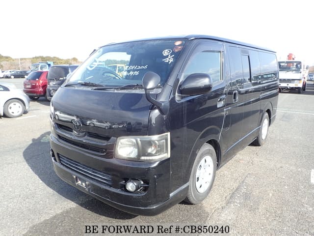 A grey JDM sports car speeding down a highway at night.