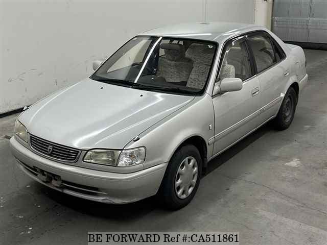 A grey JDM sports car speeding down a highway at night.