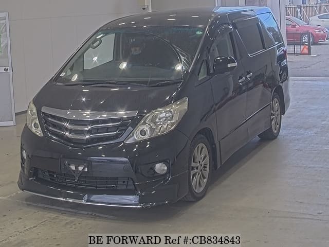 A grey JDM sports car speeding down a highway at night.