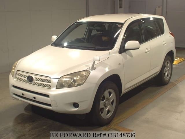 A grey JDM sports car speeding down a highway at night.