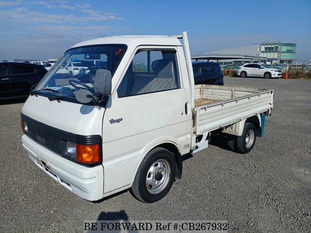 A grey JDM sports car speeding down a highway at night.