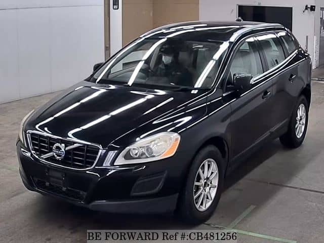 A grey JDM sports car speeding down a highway at night.