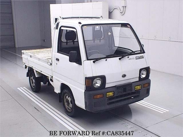 A grey JDM sports car speeding down a highway at night.