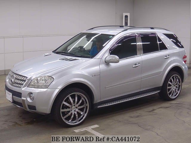 A grey JDM sports car speeding down a highway at night.